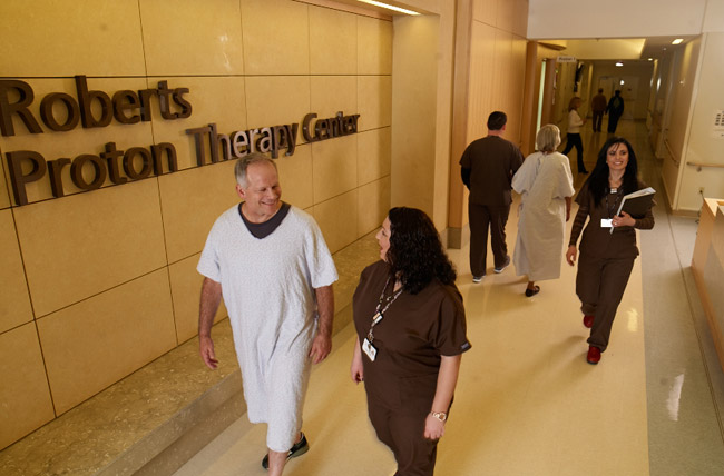 Provider and Patient walking through Roberts Proton Therapy Center